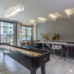 clubroom with a large kitchen island and game tables