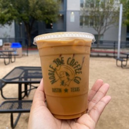 a person holding a cup of coffee