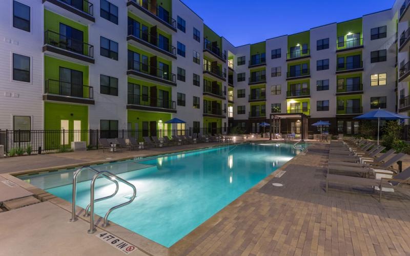 a pool in a courtyard between buildings